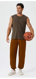 Mens loose yoga pants and sleeveless vest set showing breathable fabric and elastic cuffs