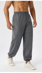Detail of grey men's yoga joggers featuring drawstring waist and soft knit fabric texture