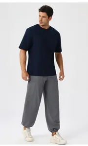 Full body studio shot of men's loose blue short sleeve T-shirt and grey joggers set