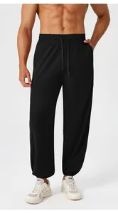 Detail view of men's athletic jogger pants with elastic drawstring waist and cuffed hems