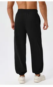 Detail view of men's loose yoga joggers featuring elastic waist and back fit design