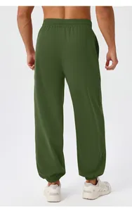Back view of men's olive green yoga pants with elastic waistband and ribbed cuffs