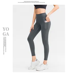 Detail of dark grey high waisted yoga leggings featuring a functional side phone pocket