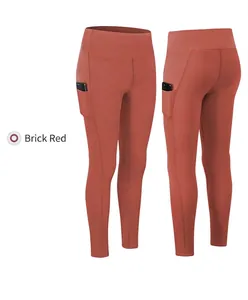 Detail of high-waisted brick red yoga leggings showing side pocket for phone storage