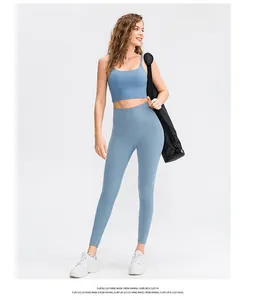 Front view of foggy blue high-waist yoga pants and matching thin strap sports bra set