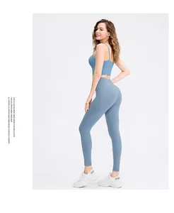 Side view of woman in dusty blue high-waisted yoga leggings and sports bra set