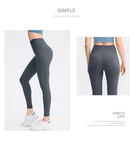 Detail view of high waisted dark gray yoga leggings showing tummy control and lift effect