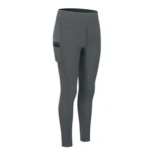 High-waisted dark grey yoga leggings with functional side pockets and tummy control