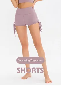 Detail view of high-waisted yoga shorts with side drawstring ties in lilac purple