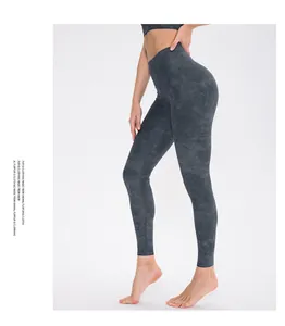 Detail view of high-waisted dark grey yoga pants with subtle cloud pattern print