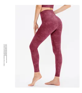 Detail view of high-waist wine red yoga leggings with seamless marble texture for fitness