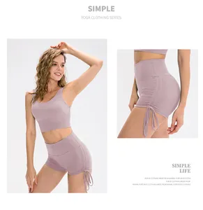 Detail view of high waist yoga shorts with side drawstring and ruched design in lilac