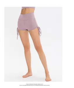 Detail of adjustable side drawstrings on lavender high-waist yoga shorts