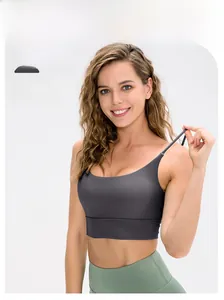 Detail of grey high-stretch yoga bra with thin straps and wide side band on female model
