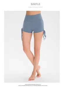 Detail view of high waist yoga shorts featuring adjustable side drawstrings in grey-blue