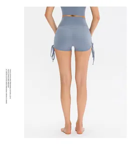 Close-up of fog blue high-waisted yoga shorts with side drawstring and ruched details