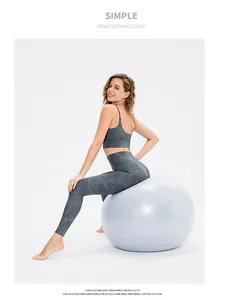 Detail of high-stretch marble print yoga set with racerback bra and leggings on yoga ball