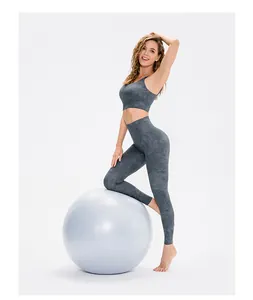 Detail of high-elastic printed yoga bra and leggings set with marble texture on grey fabric
