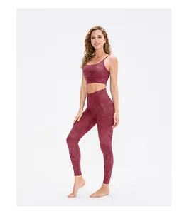 Detail of high-stretch marble print yoga set with strappy sports bra and leggings