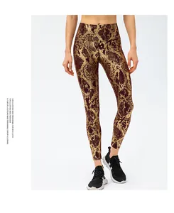Close-up of high-waist snakeskin leggings with metallic gold and brown textured pattern