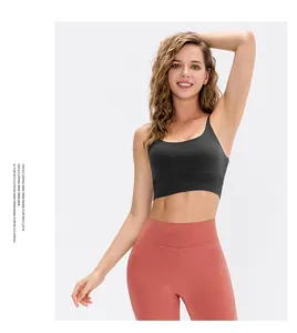 Detail view of skin-friendly black yoga sports bra and coral pink high waist leggings