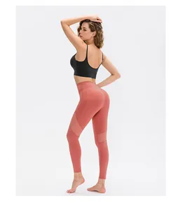 Detail of high-waist yoga leggings with breathable mesh panels and black sports bra