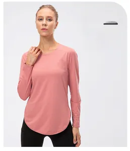Detail of loose-fit women yoga shirt in rose pink with breathable fabric texture