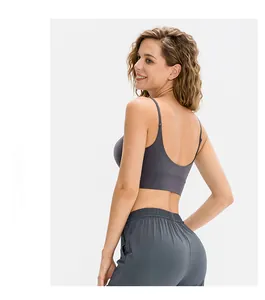 Detail of cross-back sports bra and high-waist leggings in charcoal grey stretch fabric