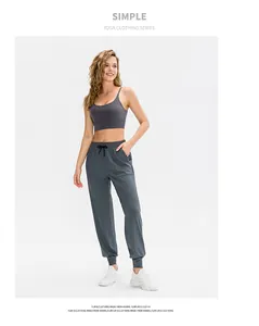 Detail view of dark grey yoga set with spaghetti strap bra and drawstring joggers