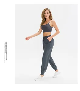Detail view of charcoal gray yoga set with strappy sports bra and drawstring joggers