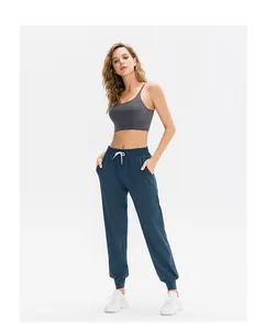 Deep grey yoga sports bra paired with navy joggers and white drawstring for fitness