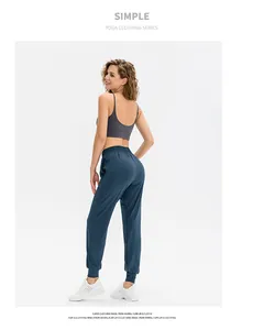 Detail of cross-back yoga bra and drawstring joggers in soft breathable fabric