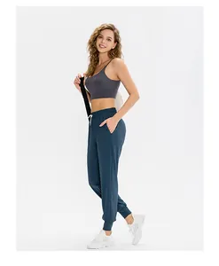 Full view of grey sports bra and dark teal joggers set for yoga and fitness training
