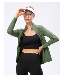 Detail of a slim-fit athletic zip-up jacket in green with high-stretch yoga leggings