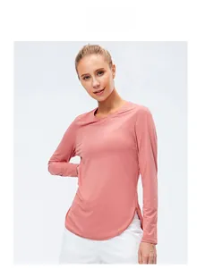 Detail of rose pink long sleeve yoga shirt showing side split and curved hem design