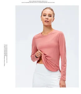 Detail of coral pink yoga top showing breathable mesh texture and crew neck design