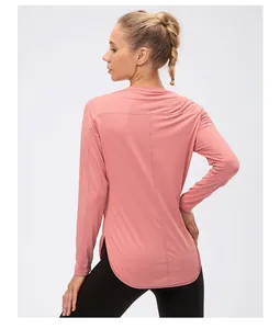 Macro shot of breathable mesh fabric and side split on a dusty pink long sleeve yoga top