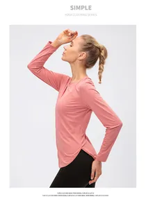 Detail view of pink long sleeve yoga top with breathable fabric and side slit hem