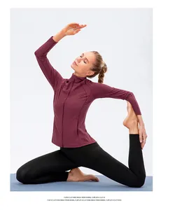 Detail showing high-stretch dark purple yoga jacket and black leggings with side pockets