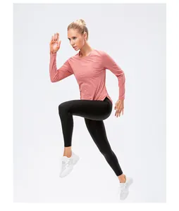 Detail of pink long sleeve yoga top and black leggings with pockets for active movement