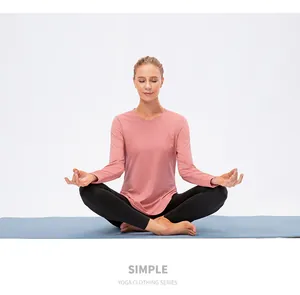 Detail of rose pink round-neck loose yoga top with breathable fabric texture and relaxed fit