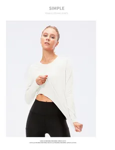 Detail of white mesh yoga top and black high-waisted leggings with side pockets
