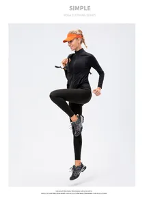 Dynamic pose of a black zip-up yoga jacket and matching leggings for women's fitness