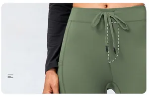 Detail of army green yoga pants featuring drawstring waist and faux zipper seam detail