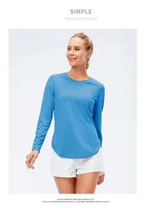 Detail view of breathable blue long sleeve yoga top with curved hem and UPF50 protection
