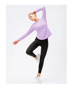 Detail of lavender long sleeve yoga top with side slit design and black leggings