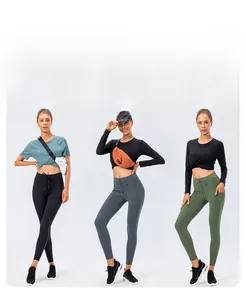 Detail of high-waisted yoga pants showing the adjustable drawstring and functional side pocket