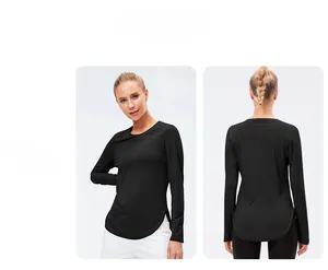 Close-up of black women's long sleeve yoga shirt with side slit and curved hem detail