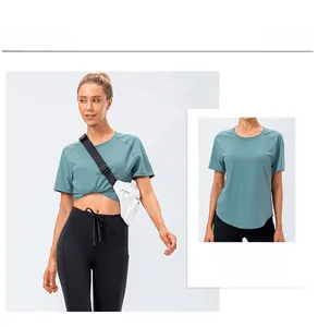 Detail view of teal short sleeve sports t-shirt and high waist black yoga pants for women