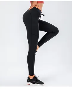 Detail of high waisted black yoga leggings featuring side pockets and adjustable drawcord
